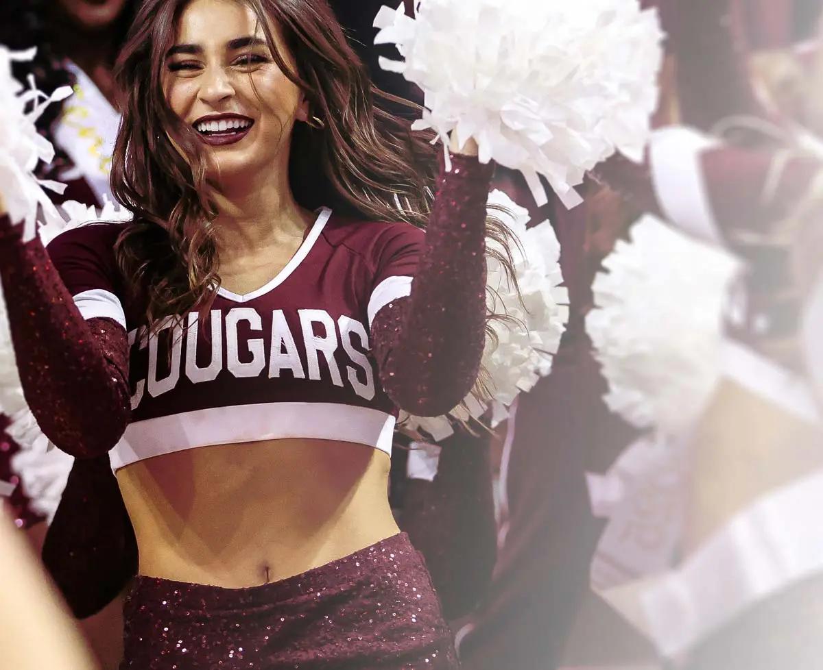 Cheerleader with pompoms cheering