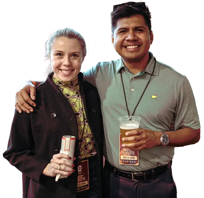 Man and woman holding drinks and smiling